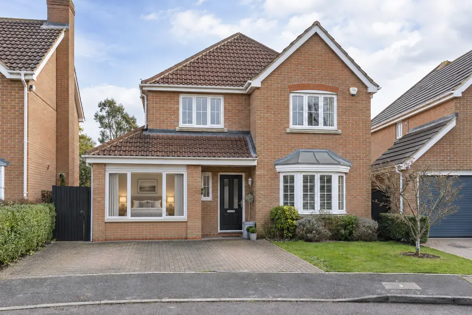 Modern detached house with its integral garage converted into a room behind a new front window